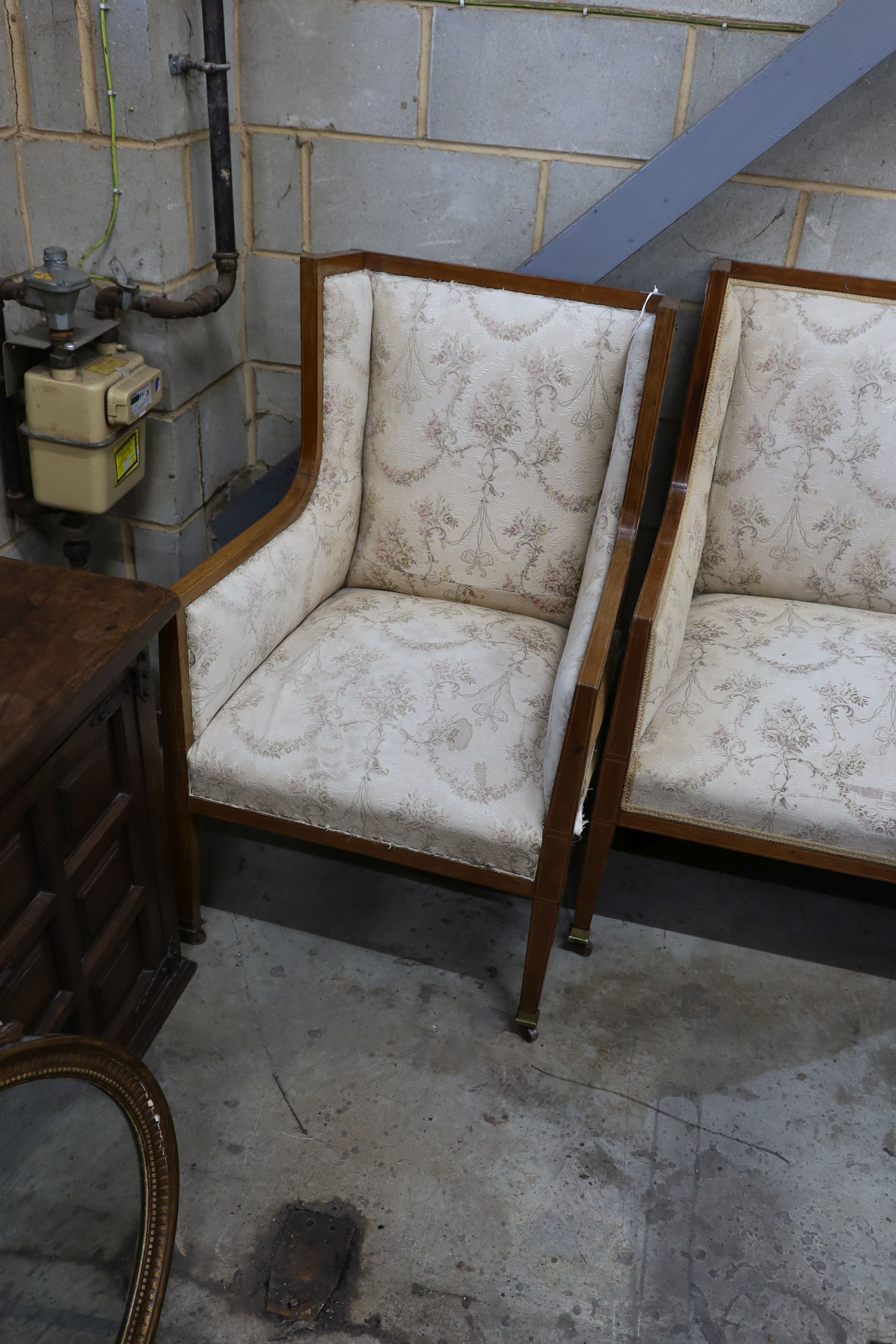 An Edwardian inlaid mahogany three piece salon suite, settee length 143cm, depth 70cm, height 104cm